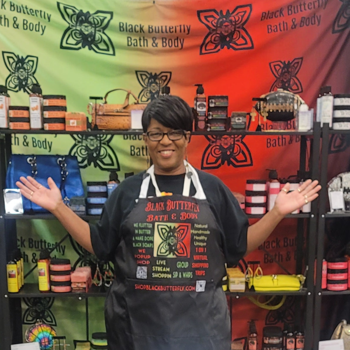 Gloria Henry- Manor posing in front of her Black Butterfly Bath & Body at The Texas Women's Conference 2024