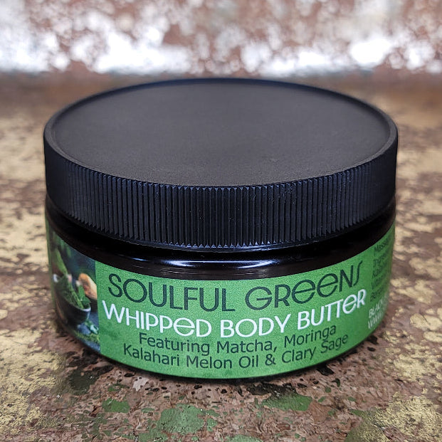 Soulful Green whipped matcha infused body butter jar on a textured surface