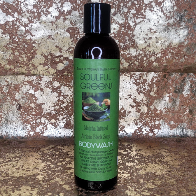 Bottle of Soulful Greens Matcha Bodywash with green label against a textured stone wall background