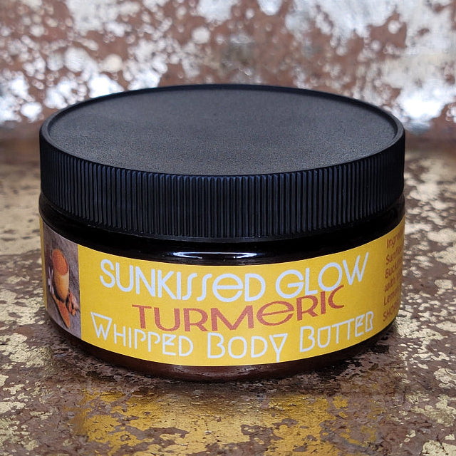 Jar of Sunkissed Glow Turmeric Whipped Body Butter on a textured surface